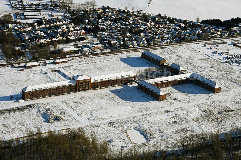 Aerial image Bernau - Wintry snowy construction site for the renovation and reconstruction of the building complex of the former military barracks on Schwanbecker Chaussee in the district Lindow in Bernau in the state Brandenburg, Germany