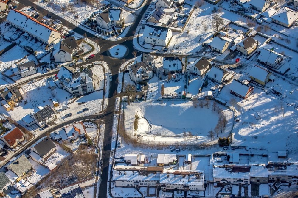 Arnsberg from above - Wintery snowely - traffic of a circle - street course hunter's place in the district of Wennigloh in Arnsberg in the federal state North Rhine-Westphalia