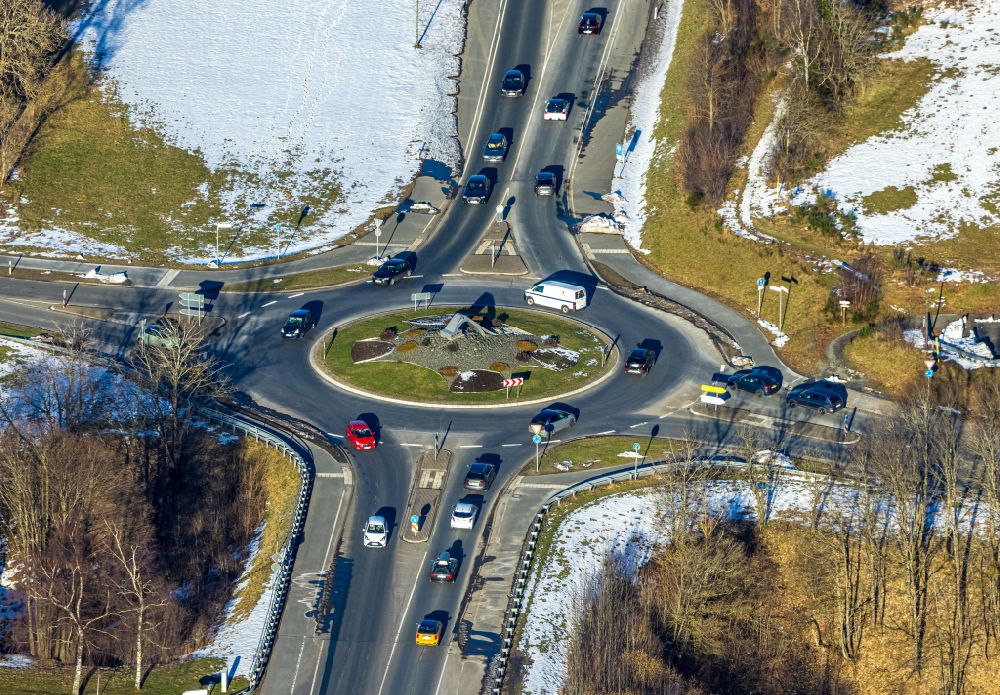 Winterberg from the bird's eye view: Wintry snowy traffic management of the roundabout road on street Haarfelder Strasse in Winterberg at Sauerland in the state North Rhine-Westphalia, Germany