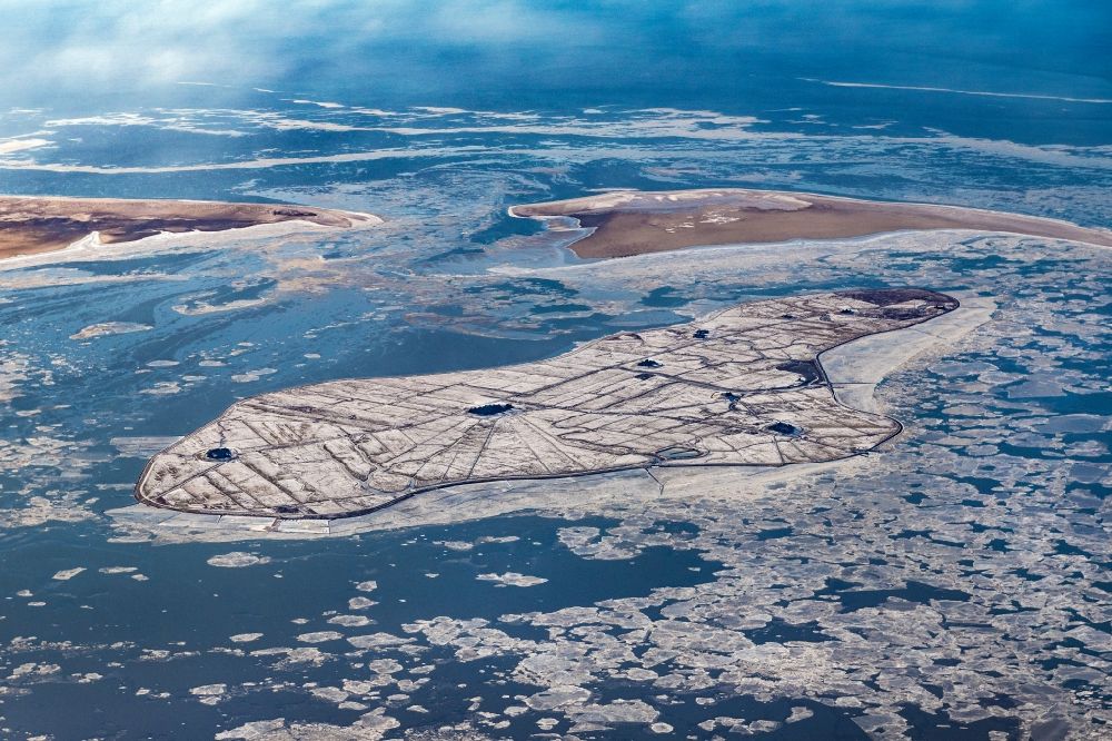 Aerial image Hooge - Wintry snowy coastal area of the North Sea Halligen - Island in Hooge in the state Schleswig-Holstein
