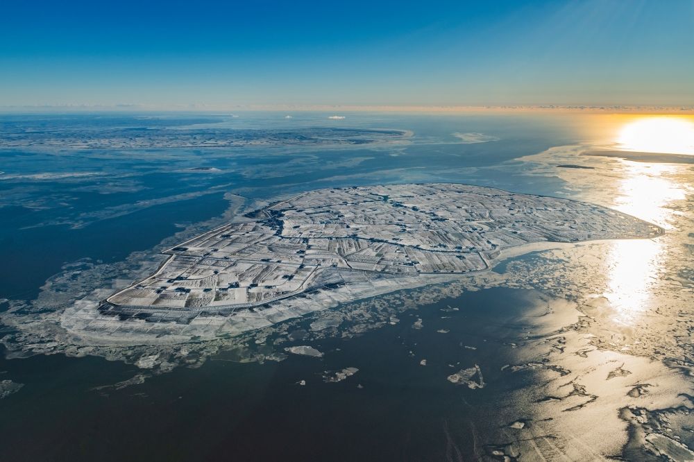 Pellworm from the bird's eye view: Wintry snowy coastal area of the North Sea - Island in Pellworm in the state Schleswig-Holstein