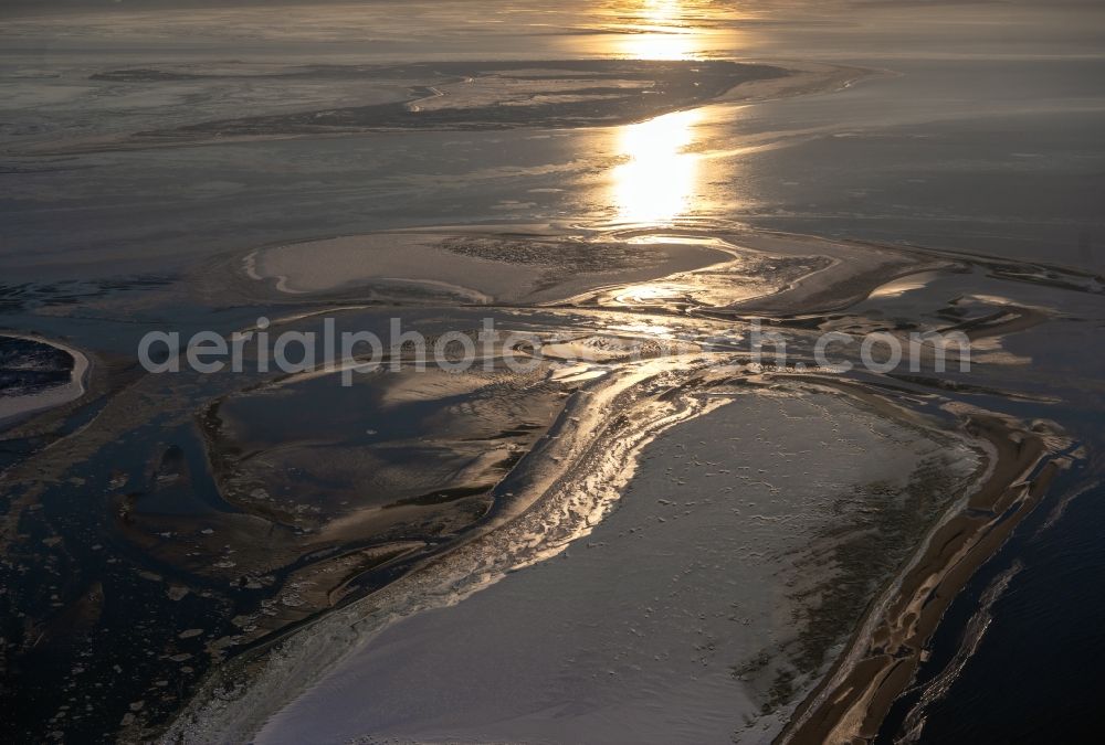 Aerial photograph Juist - Wintry snow-covered coastal area at the west end of the North Sea - island of Juist with ice-covered Wadden Sea at sunset in the state of Lower Saxony, Germany