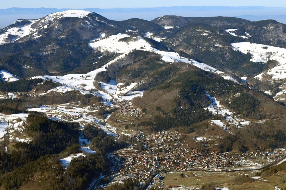 Schönau im Schwarzwald from the bird's eye view: Wintry snowy mountains of the Black Forest with Belchen and city area of Schoenau in the Black Forest in the state Baden-Wurttemberg, Germany