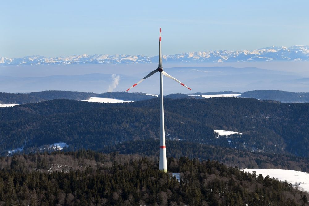 Aerial image Schopfheim - Wintry snowy landscape at the snow covered Rohrenkopf, the local mountain of Gersbach, a district of Schopfheim in Baden-Wuerttemberg. Wind turbines produce renewable energy in the wind farm. Looking over the mountains of the Black Forest to the Swiss Alps