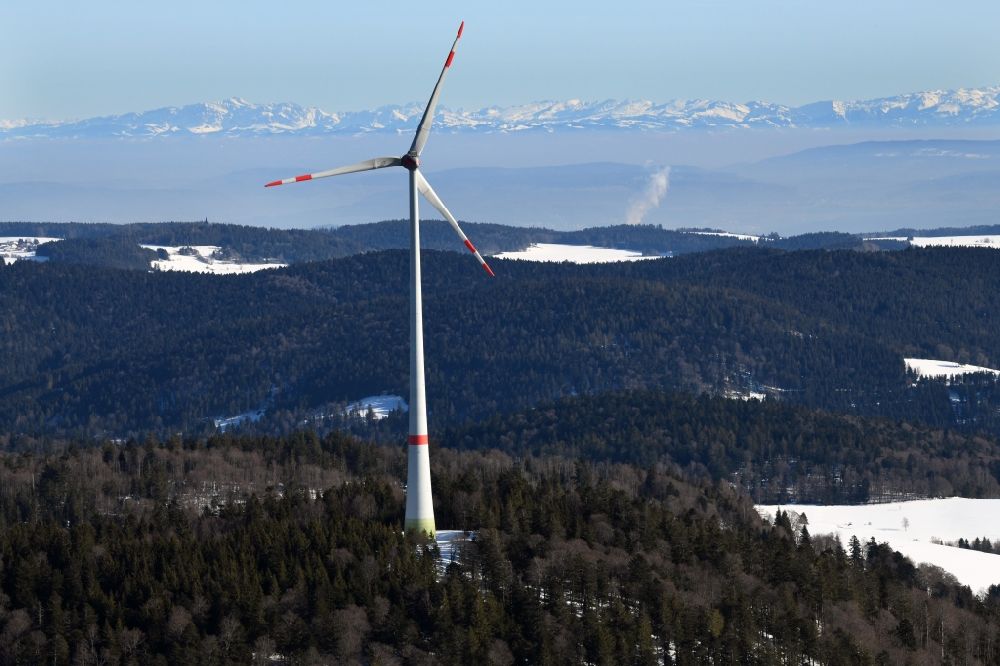 Schopfheim from above - Wintry snowy landscape at the snow covered Rohrenkopf, the local mountain of Gersbach, a district of Schopfheim in Baden-Wuerttemberg. Wind turbines produce renewable energy in the wind farm. Looking over the mountains of the Black Forest to the Swiss Alps