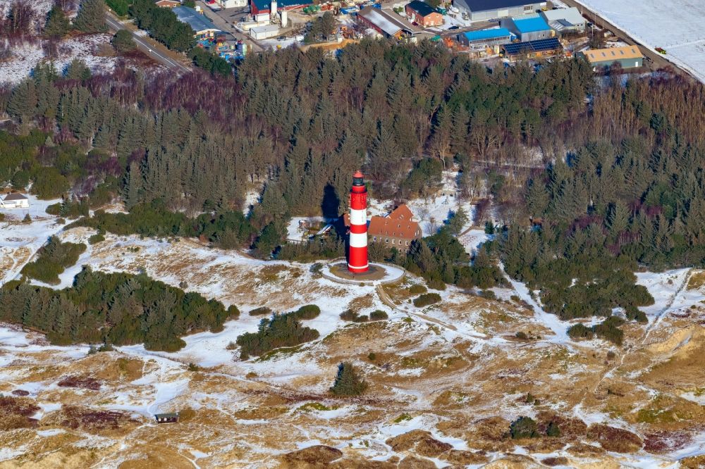 Aerial photograph Nebel - Wintry snowy lighthouse as a historic seafaring character in the coastal area of the North Sea in Wittduen auf Amrum in the state Schleswig-Holstein
