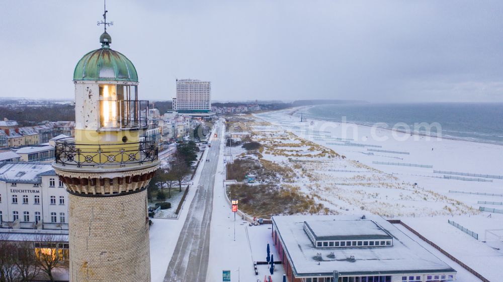 Rostock from the bird's eye view: Wintry snowy lighthouse as a historic seafaring character in the coastal area of Baltic Sea in the district Warnemuende in Rostock in the state Mecklenburg - Western Pomerania, Germany