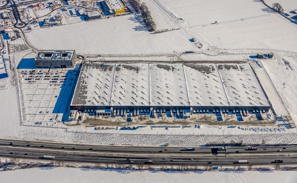 Aerial image Kamen - Wintry snowy building complex of the premises of the logistics center of Woolworth GmbH in the inter-communal commercial area on the Kamen Karree in Kamen in the state North Rhine-Westphalia, Germany