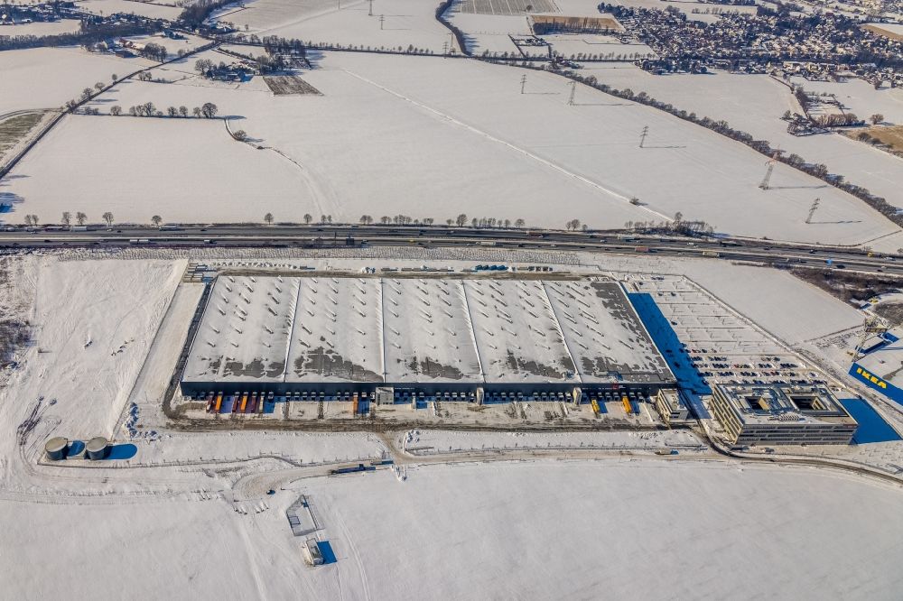 Kamen from the bird's eye view: Wintry snowy building complex of the premises of the logistics center of Woolworth GmbH in the inter-communal commercial area on the Kamen Karree in Kamen in the state North Rhine-Westphalia, Germany