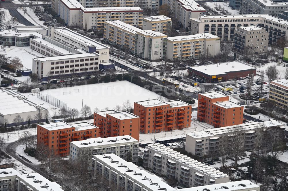 Berlin from above - Wintry snowy multi-family residential complex Gothaer Strasse - Alte Hellersdorfer Strasse in the district Hellersdorf in Berlin, Germany