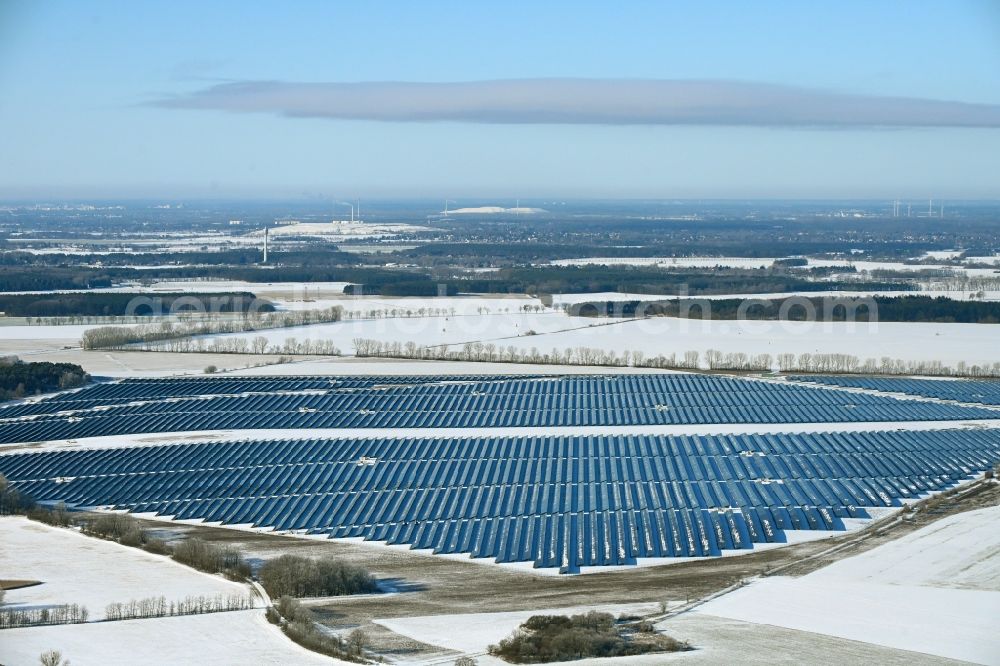 Aerial image Willmersdorf - Wintry snowy construction site and assembly work for solar park and solar power plant Solarpark Weesow-Willmersdorf in Willmersdorf in the state Brandenburg, Germany