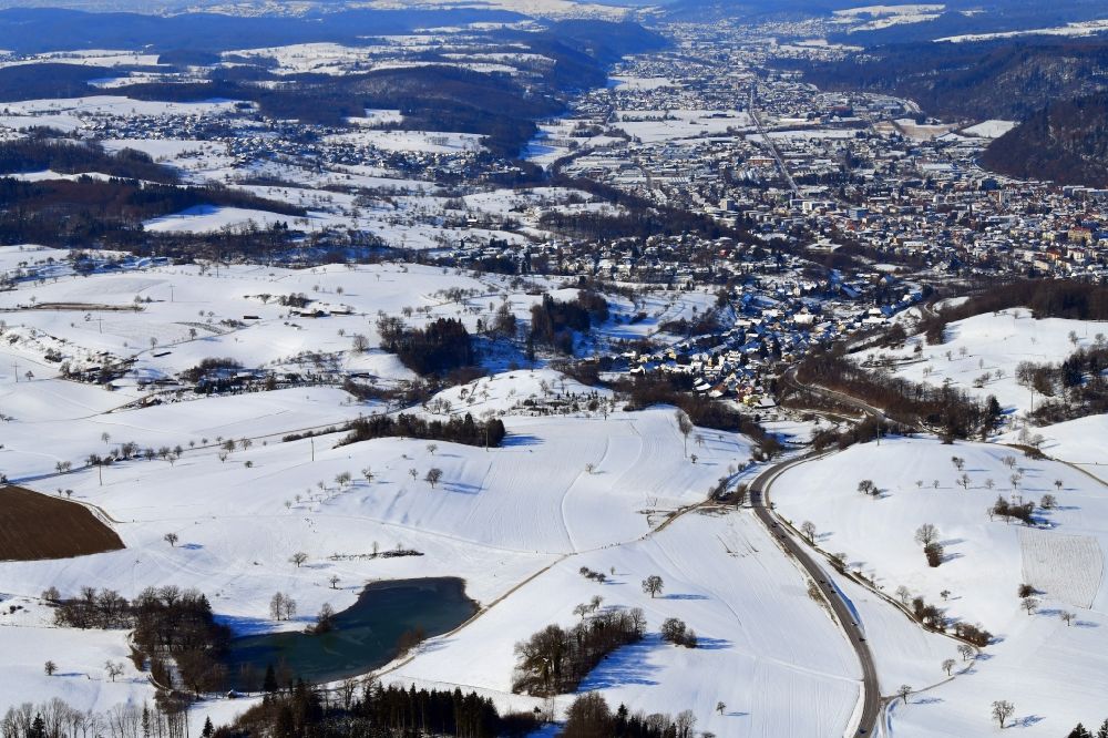 Aerial photograph Schopfheim - Wintry snowy landscape at Schopfheim in Baden-Wuerttemberg with the nature reserve Eichener See. The lake in the karst appears only after heavy rainfall and sometimes remains for years disappeared