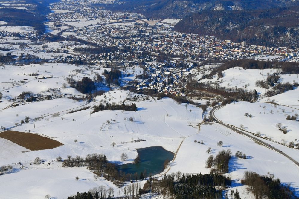 Schopfheim from the bird's eye view: Wintry snowy landscape at Schopfheim in Baden-Wuerttemberg with the nature reserve Eichener See. The lake in the karst appears only after heavy rainfall and sometimes remains for years disappeared