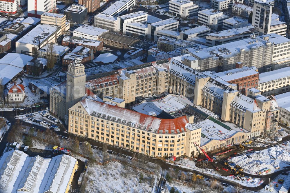 Berlin from above - Wintry snowy new building construction site in the industrial park Behrensbau on Behrens- Ufer of Spree on street Ostendstrasse in the district Oberschoeneweide in the district Schoeneweide in Berlin, Germany