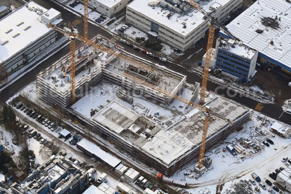 Berlin from above - Wintry snowy construction site to build a new office and commercial building INK Berlin - Inspire Neukoelln on Ballinstrasse - Woermannkehre in the district Neukoelln in Berlin, Germany