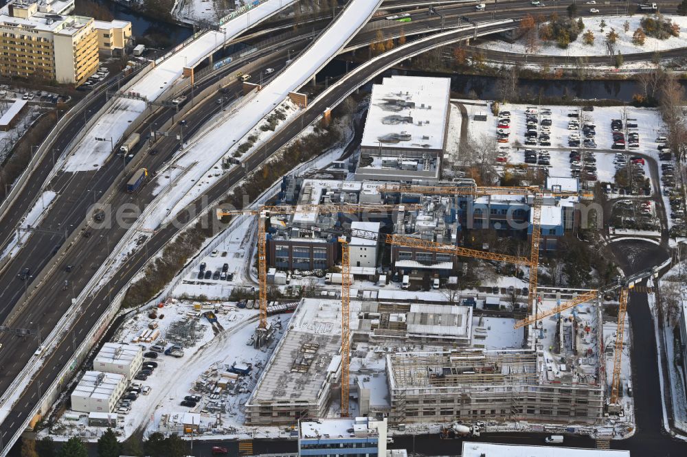 Berlin from the bird's eye view: Wintry snowy construction site to build a new office and commercial building INK Berlin - Inspire Neukoelln on Ballinstrasse - Woermannkehre in the district Neukoelln in Berlin, Germany