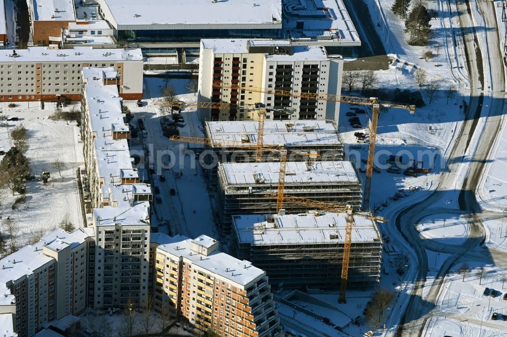 Aerial photograph Rostock - Wintry snowy construction site to build a new office and commercial building on Bahnhofsvorplatz in the district Suedstadt in Rostock in the state Mecklenburg - Western Pomerania, Germany