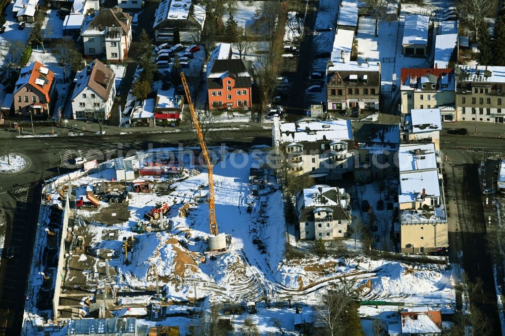 Aerial photograph Berlin - Wintry snowy new construction of the building complex of the LIDL - shopping center on street Giesestrasse corner Hoenoer Strasse in the district Mahlsdorf in Berlin, Germany