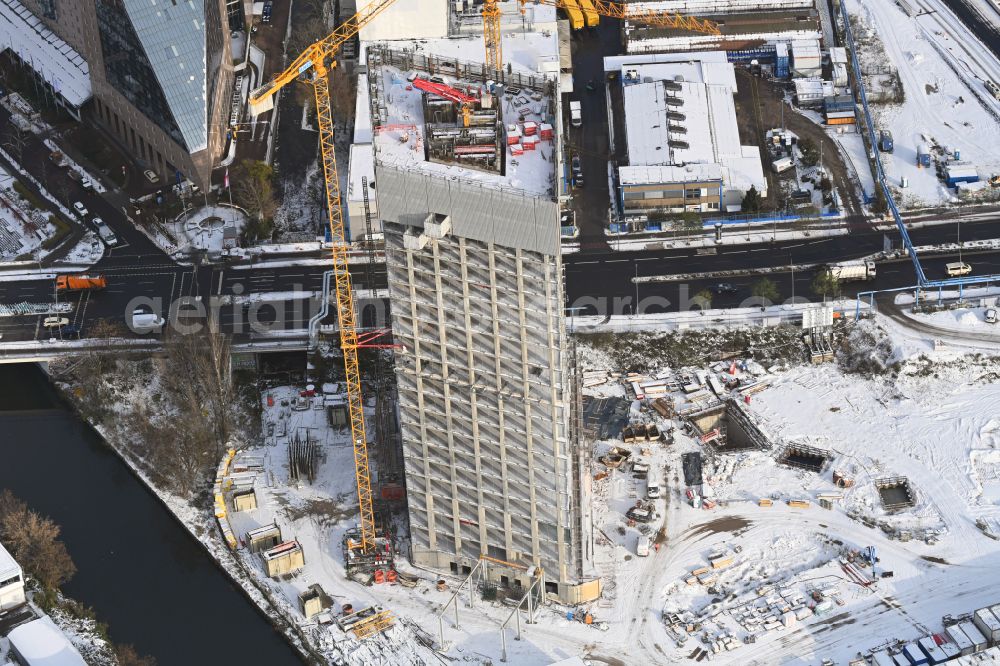 Aerial image Berlin - Wintry snowy new construction high-rise construction site the hotel complex Estrel Tower on street Sonnenallee in the district Neukoelln in Berlin, Germany