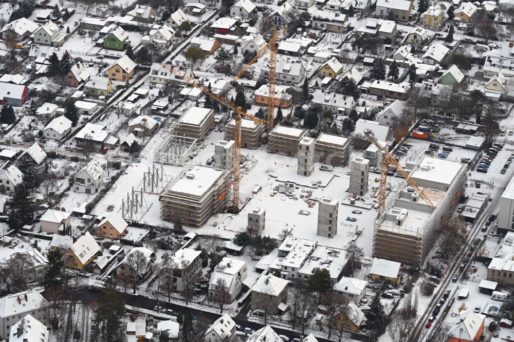 Berlin from above - Wintry snowy construction site to build a new multi-family residential complex on street Muensterberger Weg in the district Kaulsdorf in Berlin, Germany