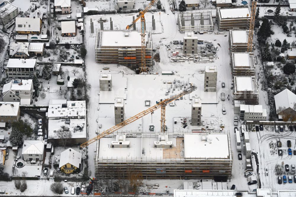 Aerial image Berlin - Wintry snowy construction site to build a new multi-family residential complex on street Muensterberger Weg in the district Kaulsdorf in Berlin, Germany