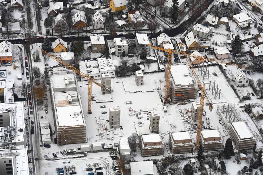 Berlin from above - Wintry snowy construction site to build a new multi-family residential complex on street Muensterberger Weg in the district Kaulsdorf in Berlin, Germany