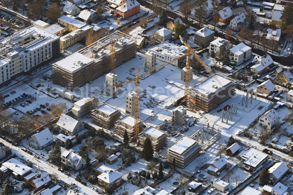 Aerial photograph Berlin - Wintry snowy construction site to build a new multi-family residential complex on street Muensterberger Weg in the district Kaulsdorf in Berlin, Germany