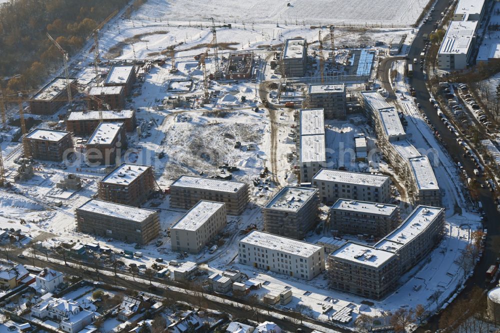 Aerial photograph Berlin - Wintry snowy construction site to build a new multi-family residential complex Buckower Felder on street Gerlinger Strasse in the district Buckow in Berlin, Germany