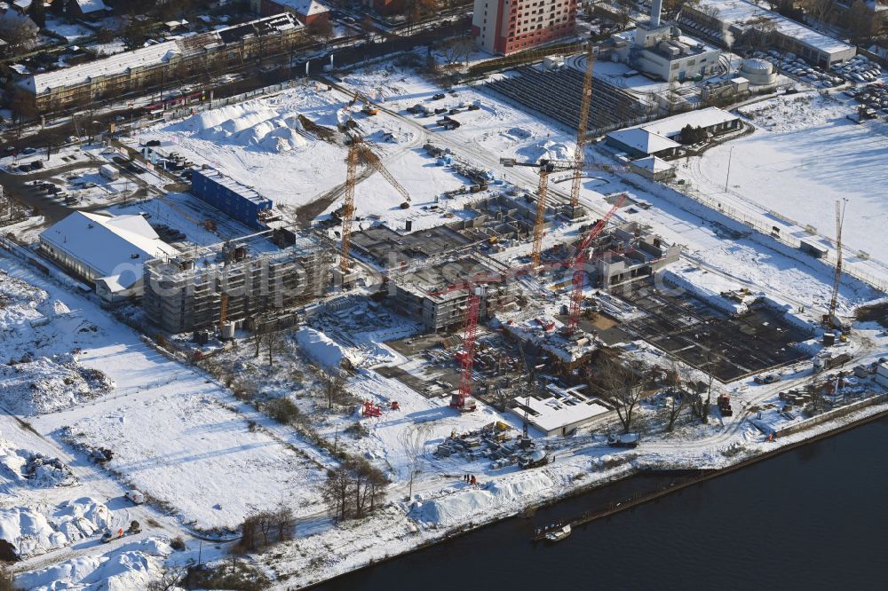 Aerial image Berlin - Wintry snowy construction site to build a new multi-family residential complex on street Wendenschlossstrasse in the district Koepenick in Berlin, Germany