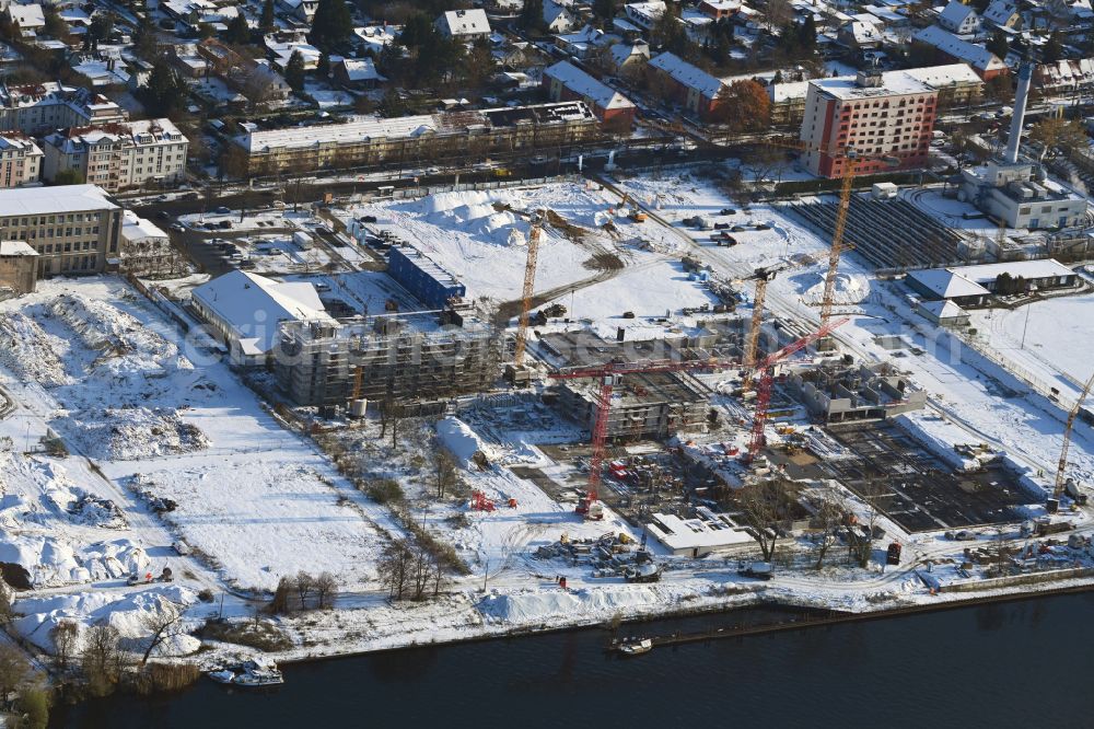 Aerial photograph Berlin - Wintry snowy construction site to build a new multi-family residential complex on street Wendenschlossstrasse in the district Koepenick in Berlin, Germany