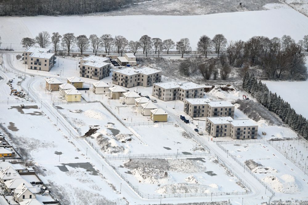 Aerial image Biesenthal - Wintry snowy construction site to build a new multi-family residential complex Naturquartier in Biesenthal in the state Brandenburg, Germany