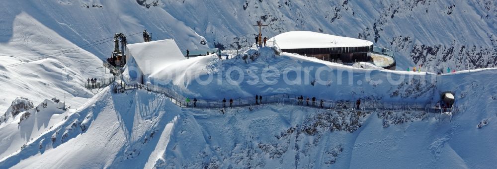 Aerial photograph Oberstdorf - Wintry snowy newly opened peak station of the Nebelhornbahn in Oberstdorf in the state of Bavaria. The summit restaurant was designed by architect Hermann Kaufmann. Guests can walk around the summit via the Nordwandsteig