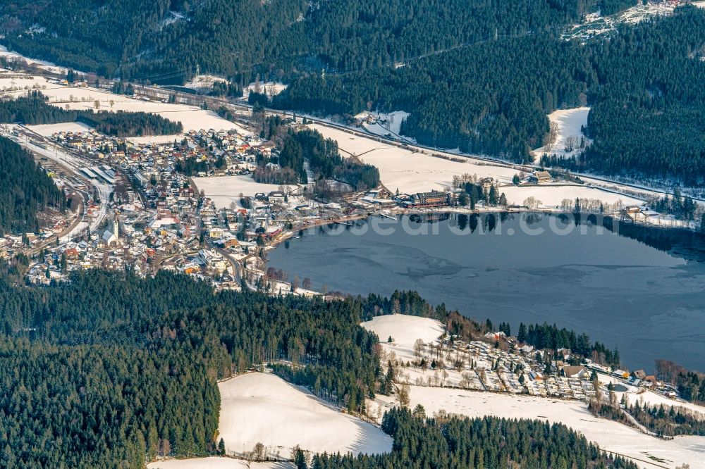 Aerial image Titisee - Wintry snowy town View of the streets and houses of the residential areas in Titisee in the state Baden-Wurttemberg, Germany