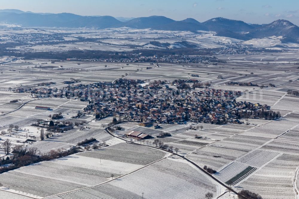 Nußdorf from the bird's eye view: Wintry snowy town center on the edge of vineyards and wineries in the wine-growing area in Nussdorf in the state Rhineland-Palatinate, Germany