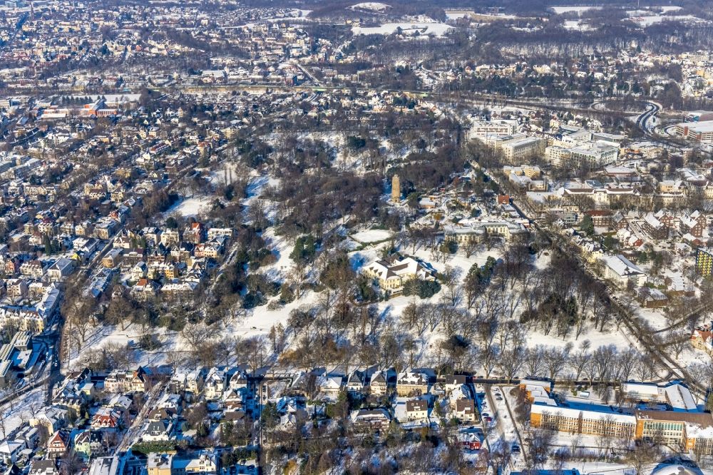 Aerial image Bochum - Wintry snowy park of the Stadtpark Bochum overlooking the gastronomy building and the Bismarck tower in Stadtparkviertel in Bochum at Ruhrgebiet in the state North Rhine-Westphalia, Germany