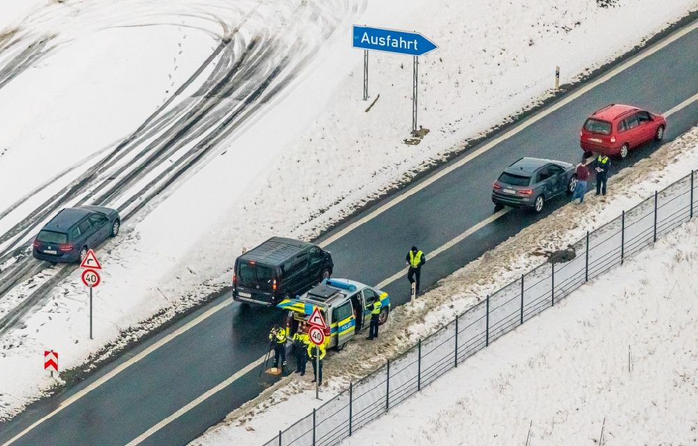 Aerial photograph Nuttlar - Wintry snowy officials in a police operation to a speed control and Traffic control on federal motorway B480 in Nuttlar in the state North Rhine-Westphalia, Germany