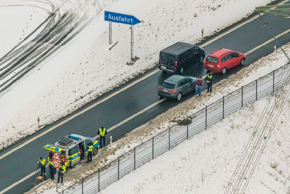 Nuttlar from above - Wintry snowy officials in a police operation to a speed control and Traffic control on federal motorway B480 in Nuttlar in the state North Rhine-Westphalia, Germany