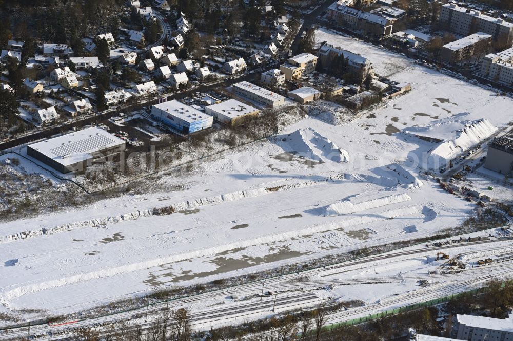 Aerial photograph Berlin - Wintry snowy demolition of the building of the branch of the Hellweg-Die Profibaumaerkte GmbH & Co. KG DIY store on Attilastrasse in Berlin