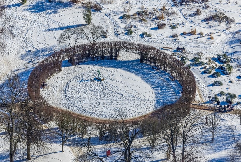 Aerial image Essen - Wintry snow-covered roundabout in the park of the Grugapark Essen with a bronze sculpture Javelin thrower by Erich Seger on Luehrmannstrasse in the Ruettenscheid part of Essen in the state North Rhine-Westphalia, Germany