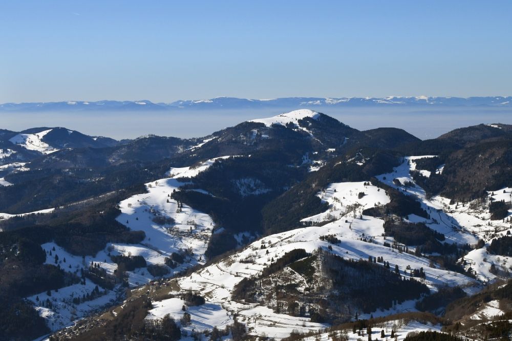 Aerial photograph Schönenberg - Wintry snowy mountains in the Black Forest at Schoenenberg in the state Baden-Wurttemberg, Germany. Looking over the bold summit of Belchen to the mountain range of the Vosges in France