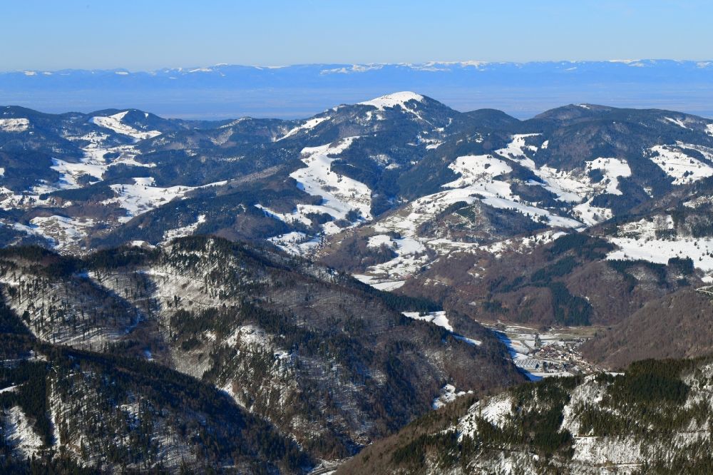 Aerial image Schönenberg - Wintry snowy mountains in the Black Forest at Schoenenberg in the state Baden-Wurttemberg, Germany. Looking over the bold summit of Belchen to the mountain range of the Vosges in France