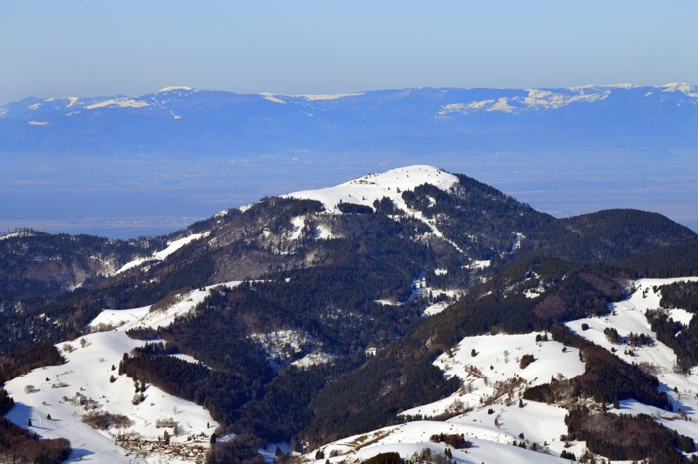 Aerial photograph Schönenberg - Wintry snowy mountain Ballon in the Black Forest at Schoenenberg in the state Baden-Wurttemberg, Germany. Looking over the bold summit to the mountain range of the Vosges in France