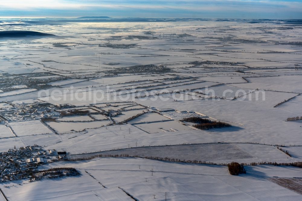 Herbsleben from the bird's eye view: Wintry snowy current route of the power lines and pylons in Doellstaedt in the state Thuringia, Germany