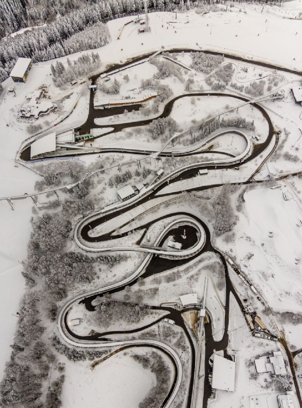 Aerial image Winterberg - Wintry snowy serpentine curve of the racetrack route of Bobbahn Winterberg Hochsauerland in Winterberg in the state North Rhine-Westphalia