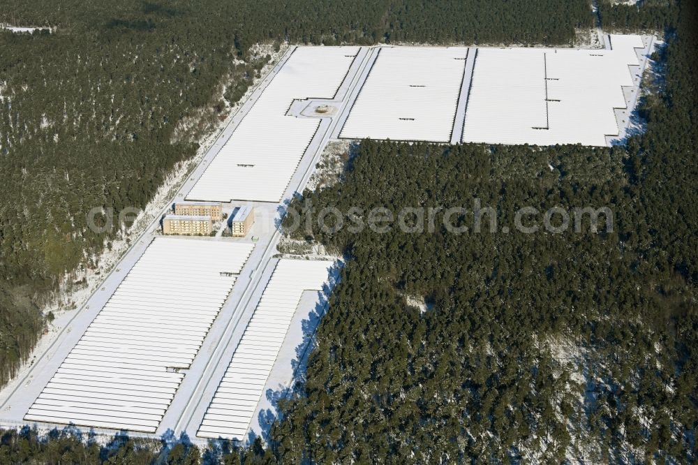 Aerial image Groß Dölln - Wintry snowy solar power plant and photovoltaic systems in Gross Doelln in the state Brandenburg, Germany