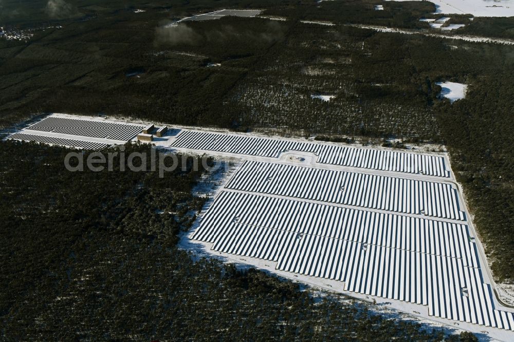 Groß Dölln from above - Wintry snowy solar power plant and photovoltaic systems in Gross Doelln in the state Brandenburg, Germany
