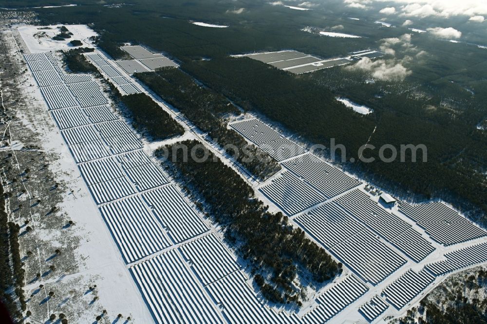 Groß Dölln from above - Wintry snowy solar power plant and photovoltaic systems in Gross Doelln in the state Brandenburg, Germany