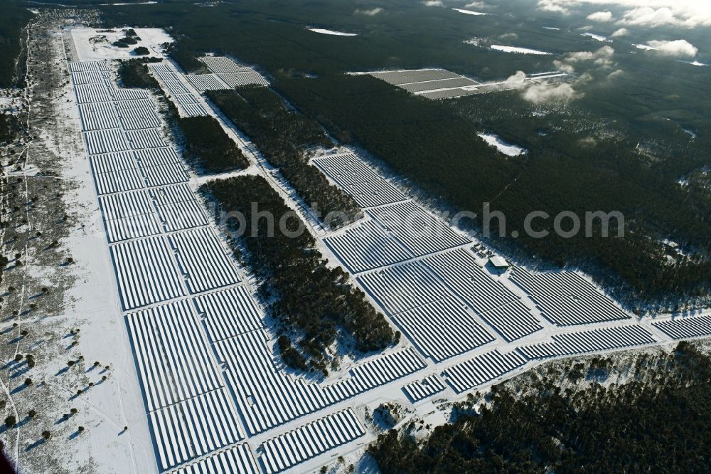 Groß Dölln from the bird's eye view: Wintry snowy solar power plant and photovoltaic systems in Gross Doelln in the state Brandenburg, Germany