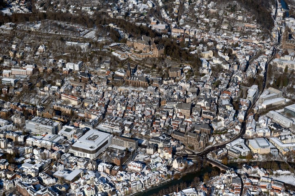 Marburg from the bird's eye view: Wintry snowy city view of the city area of in Marburg in the state Hesse, Germany