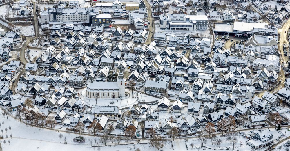 Winterberg from the bird's eye view: Wintry snowy city view on down town in Winterberg at Sauerland in the state North Rhine-Westphalia, Germany